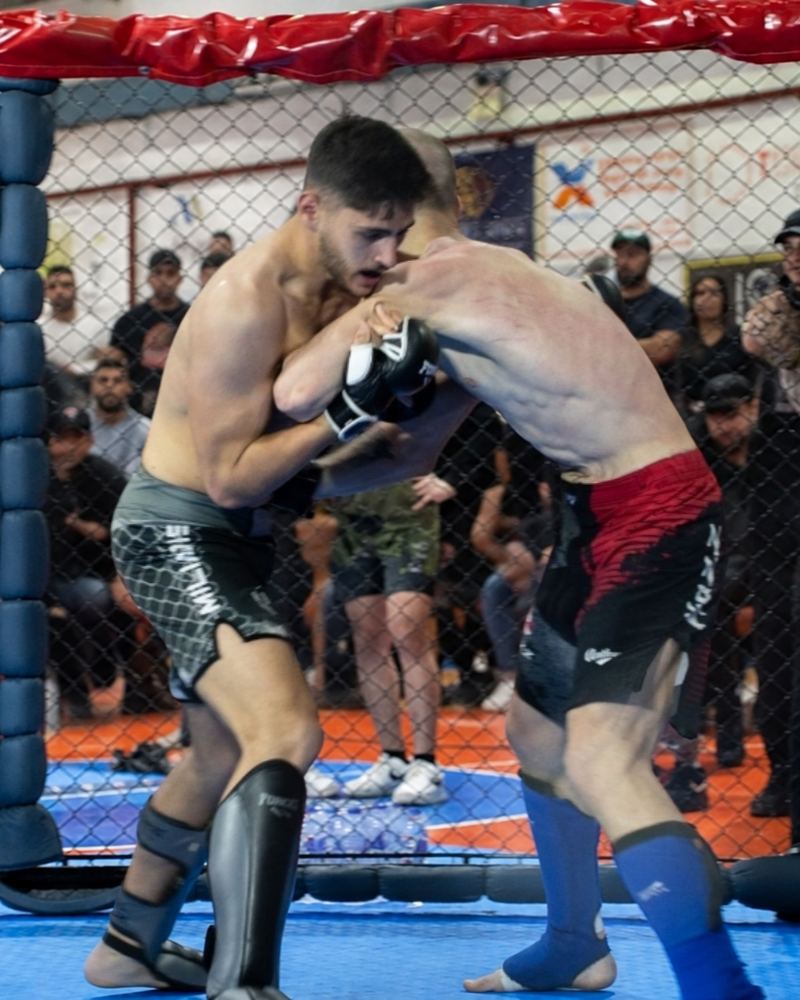 Miliadis Nikos clinching an opponent in the cage